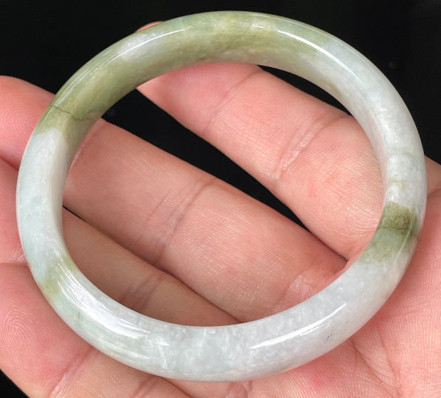 Rounded classic profile of 57mm icy greyish white and apple green Burmese jade bangle JB360