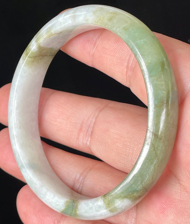 Rounded classic profile of 57mm icy greyish white and apple green Burmese jade bangle JB360