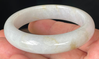Rounded classic profile of 57mm icy lavender, milky white and honey Burmese jade bangle JB359