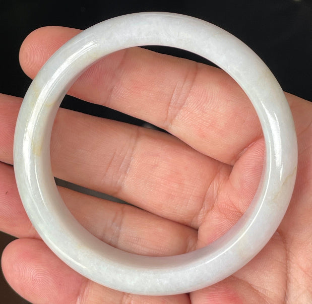 Rounded classic profile of 57mm icy lavender, milky white and honey Burmese jade bangle JB359