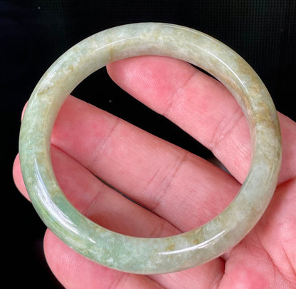 Flat inner and round outer edges of 58.2mm icy apple green, milky white, and honey brown Burmese jade bangle JB830