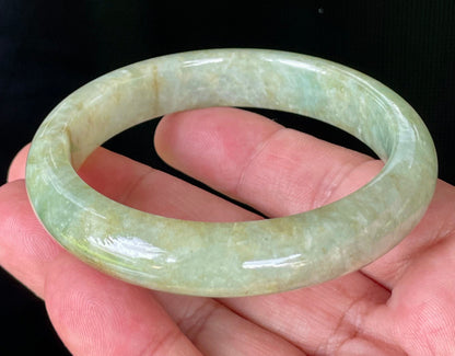 Flat inner and round outer edges of 58.2mm icy apple green, milky white, and honey brown Burmese jade bangle JB830