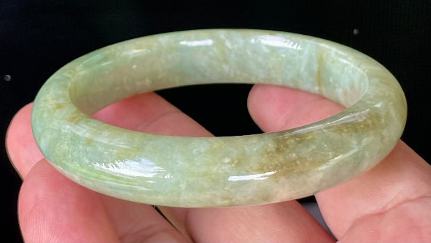 Flat inner and round outer edges of 58.2mm icy apple green, milky white, and honey brown Burmese jade bangle JB830