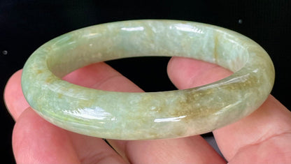 Flat inner and round outer edges of 58.2mm icy apple green, milky white, and honey brown Burmese jade bangle JB830