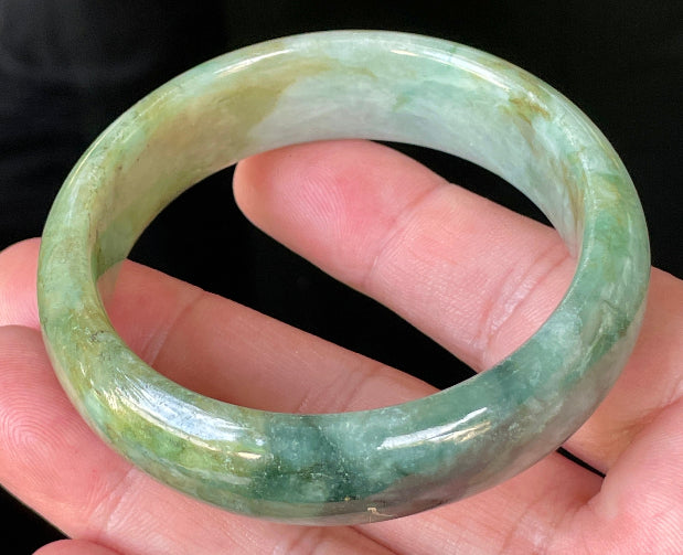 Rounded classic profile of 55mm icy bluish apple green, honey and milky white Burmese jade bangle JB233