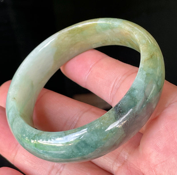 Rounded classic profile of 55mm icy bluish apple green, honey and milky white Burmese jade bangle JB233
