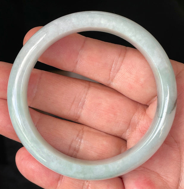 Rounded classic profile of 58.8mm icy greyish white, light apple green and bluish Burmese jade bangle JB231