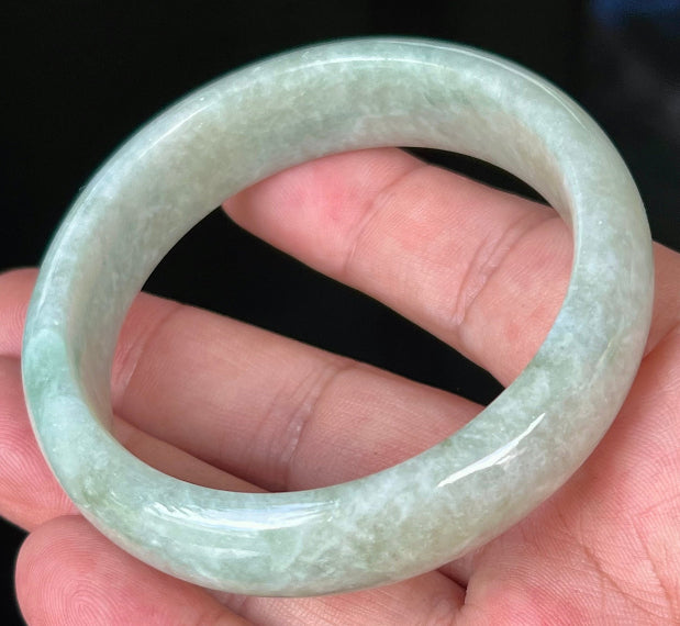 Rounded classic profile of 56.8mm icy green and white Burmese jade bangle JB537