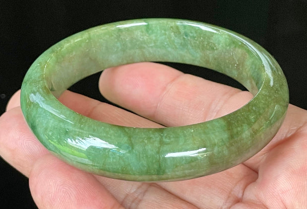 Flat inner and round outer edges of 58.5mm icy emerald and apple green Burmese jade bangle JB043