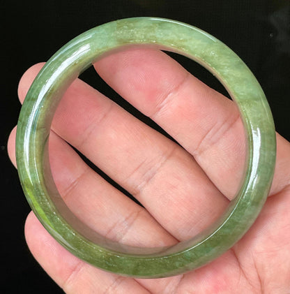Flat inner and round outer edges of 58.5mm icy emerald and apple green Burmese jade bangle JB043