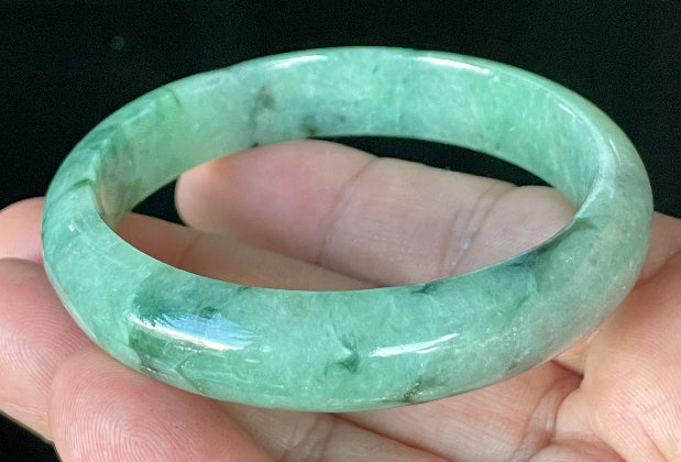 Flat inner and round outer edges of 57.5mm icy apple, imperial green, black, and white Burmese jade bangle JB911