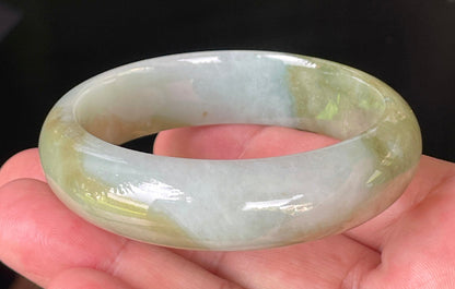 Flat inner and round outer edges of 57.5mm icy apple green, moss green, and bluish white Burmese jade bangle JB032