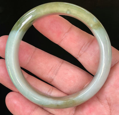Flat inner and round outer edges of 57.5mm icy apple green, moss green, and bluish white Burmese jade bangle JB032