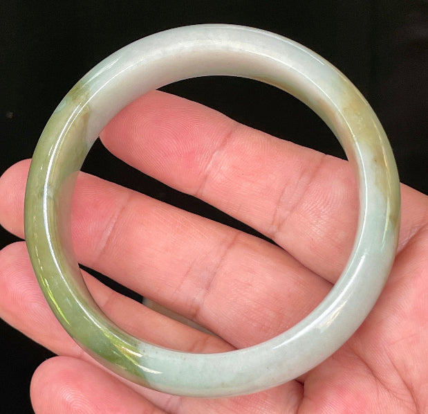 Flat inner and round outer edges of 57.5mm icy apple green, moss green, and bluish white Burmese jade bangle JB032