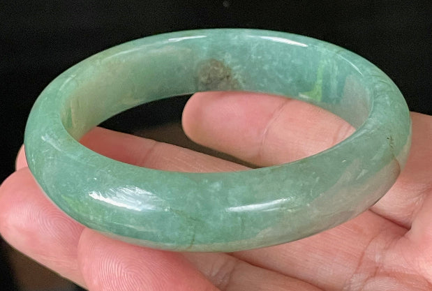 Flat inner and round outer edges of 58.4mm icy apple green, emerald green, and honey brown Burmese jade bangle JB906