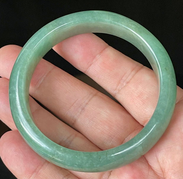 Flat inner and round outer edges of 58.4mm icy apple green, emerald green, and honey brown Burmese jade bangle JB906