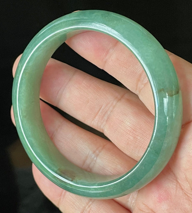 Flat inner and round outer edges of 58.4mm icy apple green, emerald green, and honey brown Burmese jade bangle JB906