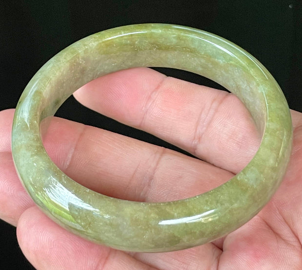 Flat inner and round outer edges of 58mm icy apple, forest green, and milky honey white Burmese jade bangle JB040