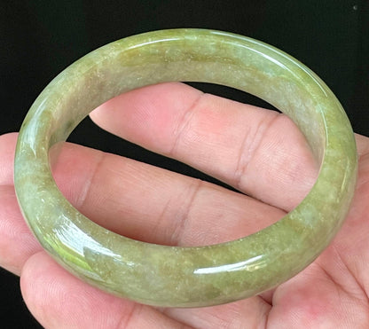 Flat inner and round outer edges of 58mm icy apple, forest green, and milky honey white Burmese jade bangle JB040