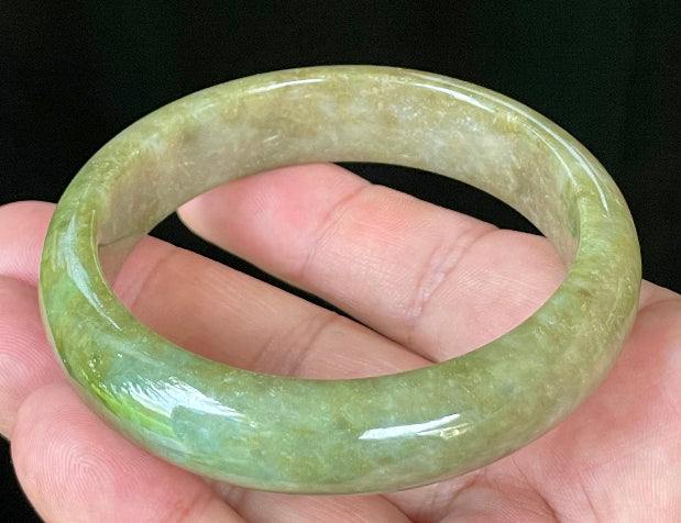 Flat inner and round outer edges of 58mm icy apple, forest green, and milky honey white Burmese jade bangle JB040