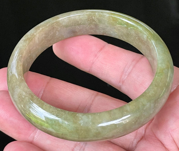 Flat inner and round outer edges of 58mm icy apple, forest green, and milky honey white Burmese jade bangle JB040