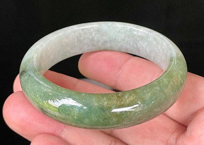 Flat inner and round outer edges of 54.8mm icy apple green, white, and black Burmese jade bangle JB050