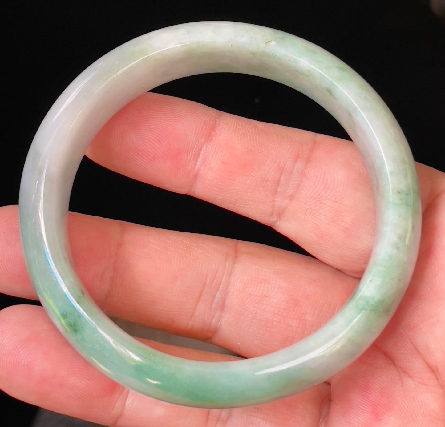 Flat inner and round outer edges of 58mm icy imperial green and greyish white Burmese jade bangle JB004