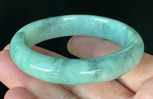 Flat inner and round outer edges of 56mm icy imperial, apple green, and milky white Burmese jade bangle JB914