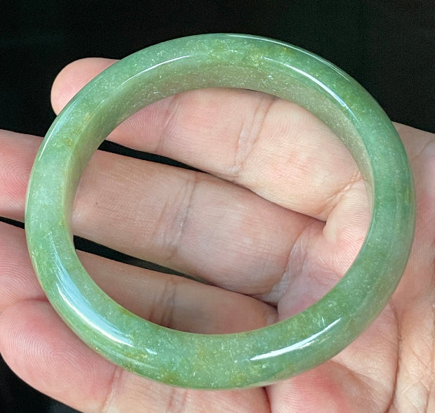 Flat inner and round outer edges of 57.6mm icy apple green, white, and honey Burmese jade bangle JB916