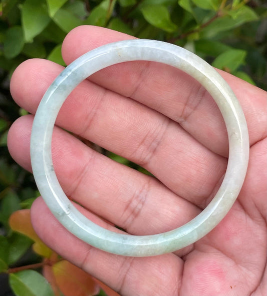 Slim profile icy white, bluish green, and gentle yellow natural Type A Burmese jade bangle bracelet in size 54.7mm