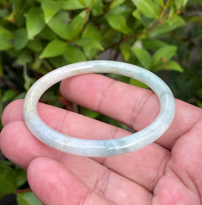 Slim profile icy white, bluish green, and gentle yellow natural Type A Burmese jade bangle bracelet in size 54.7mm