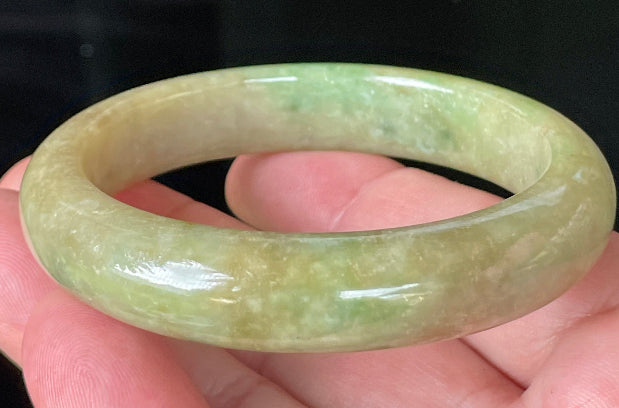 Flat inner and round outer edges of 56.9mm icy apple and imperial green Burmese jade bangle JB218