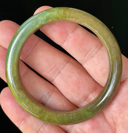Flat inner and round outer edges of 55mm icy apple green, moss green, and honey red Burmese jade bangle JB873