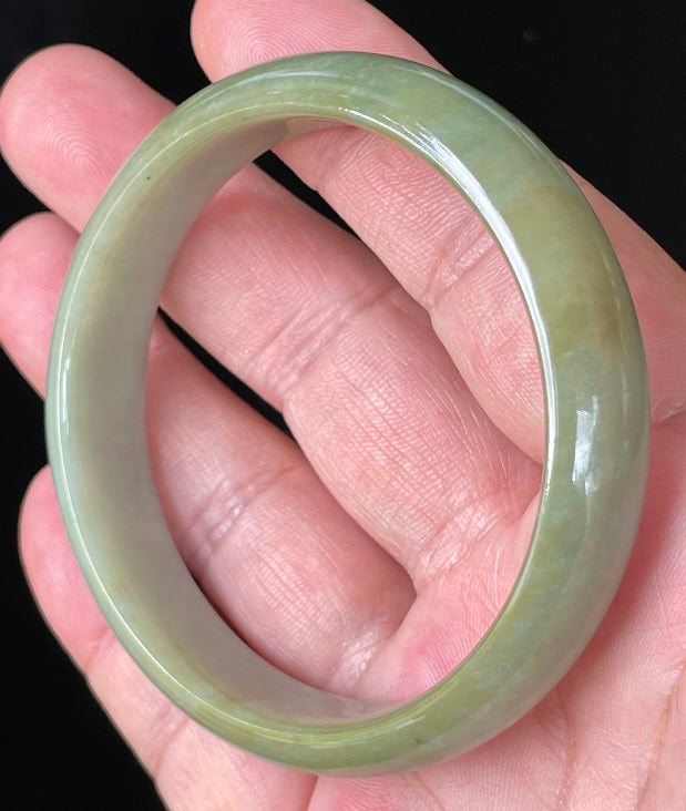 Flat inner and round outer edges of 59mm icy apple green and honey Burmese jade bangle JB213