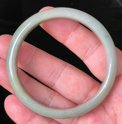 Flat inner and round outer edges of 59mm icy apple green and honey Burmese jade bangle JB213