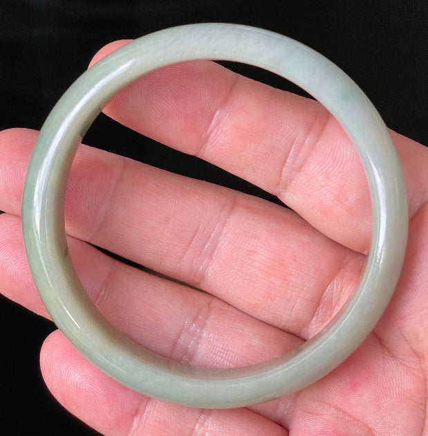 Flat inner and round outer edges of 59mm icy apple green and honey Burmese jade bangle JB213
