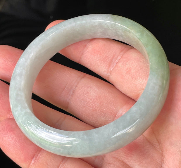Flat inner and round outer edges of 56.2mm icy apple green, greyish white, and lavender Burmese jade bangle JB203
