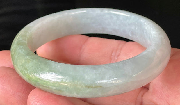Flat inner and round outer edges of 56.2mm icy apple green, greyish white, and lavender Burmese jade bangle JB203