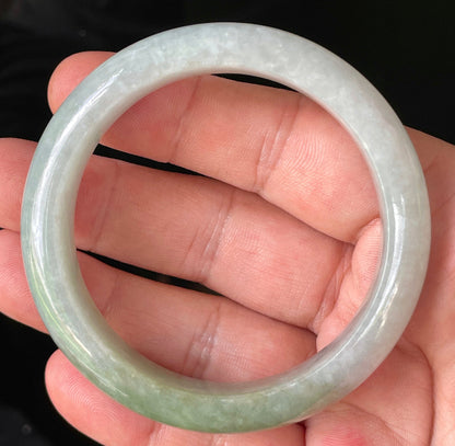Flat inner and round outer edges of 56.2mm icy apple green, greyish white, and lavender Burmese jade bangle JB203
