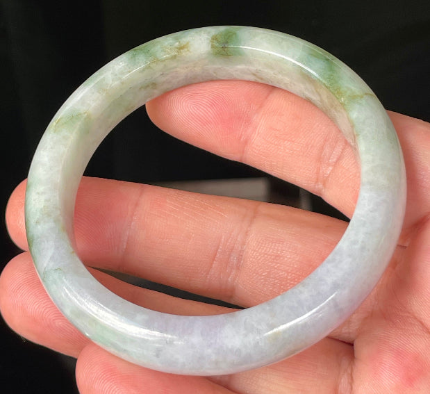 Flat inner and round outer edges of 56.7mm icy imperial green, white, and lavender Burmese jade bangle JB216