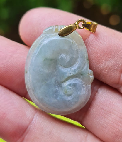 Fine texture of the authentic Myanmar jade pendant JOP005 showcasing a carved Ruyi Swirl Feng Shui design for peace and harmony