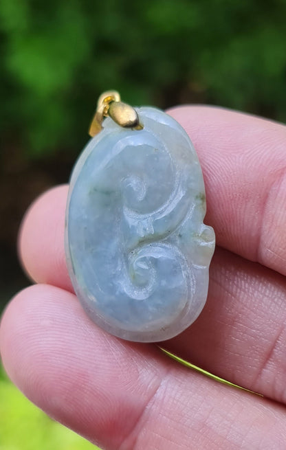 Fine texture of the authentic Myanmar jade pendant JOP005 showcasing a carved Ruyi Swirl Feng Shui design for peace and harmony