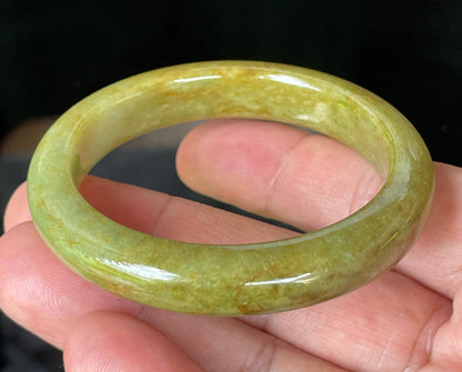 Flat inner and round outer edges of 52.4mm moss green, apple green, and brown Burmese jade bangle JB872