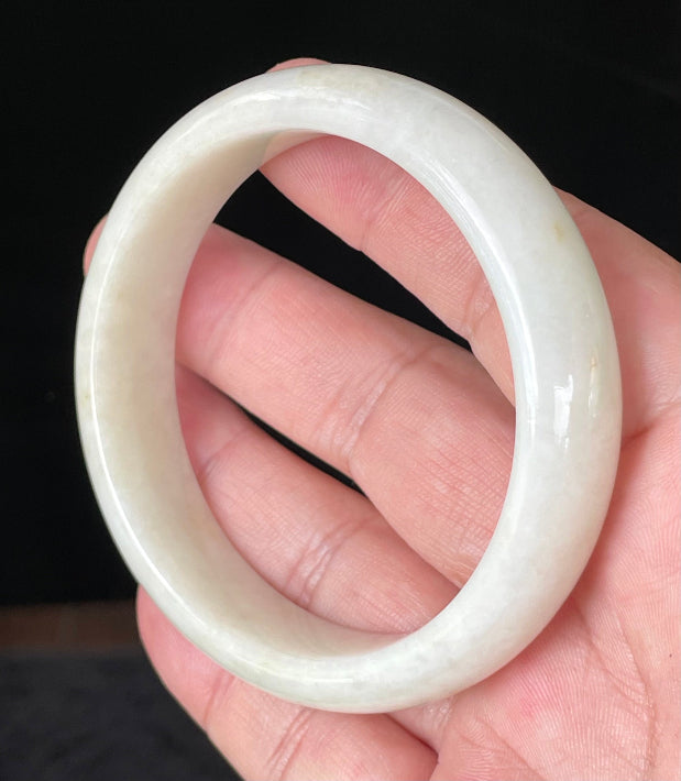 Flat inner and round outer edges of 59mm icy milky white, light yellow, and honey Burmese jade bangle JB928